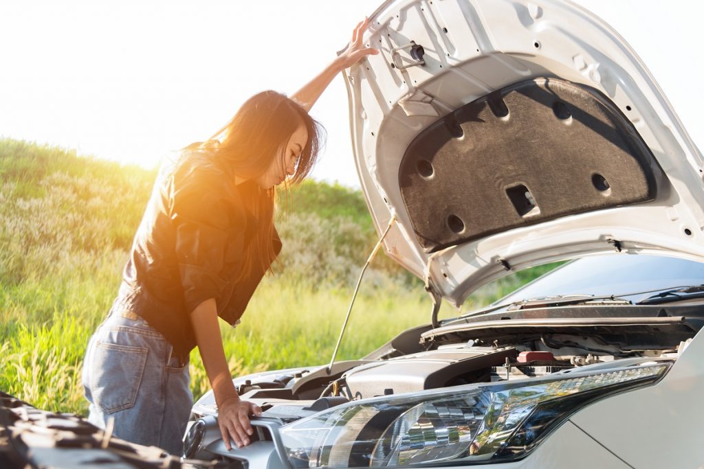 Female checking her car engine