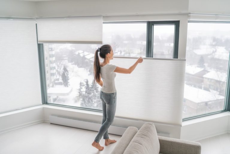 woman installing blinds