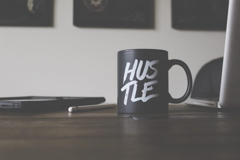 black mug with the word "hustle" written on it