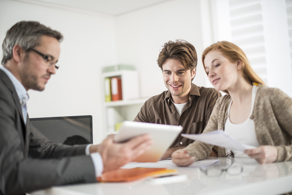 A couple buying a house from a real estate agent