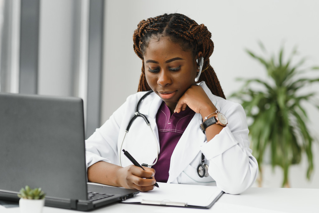 female doctor or therapist giving health care advice online by webcam videochat and consulting distant patient. Remote medical services. Telemedicine.