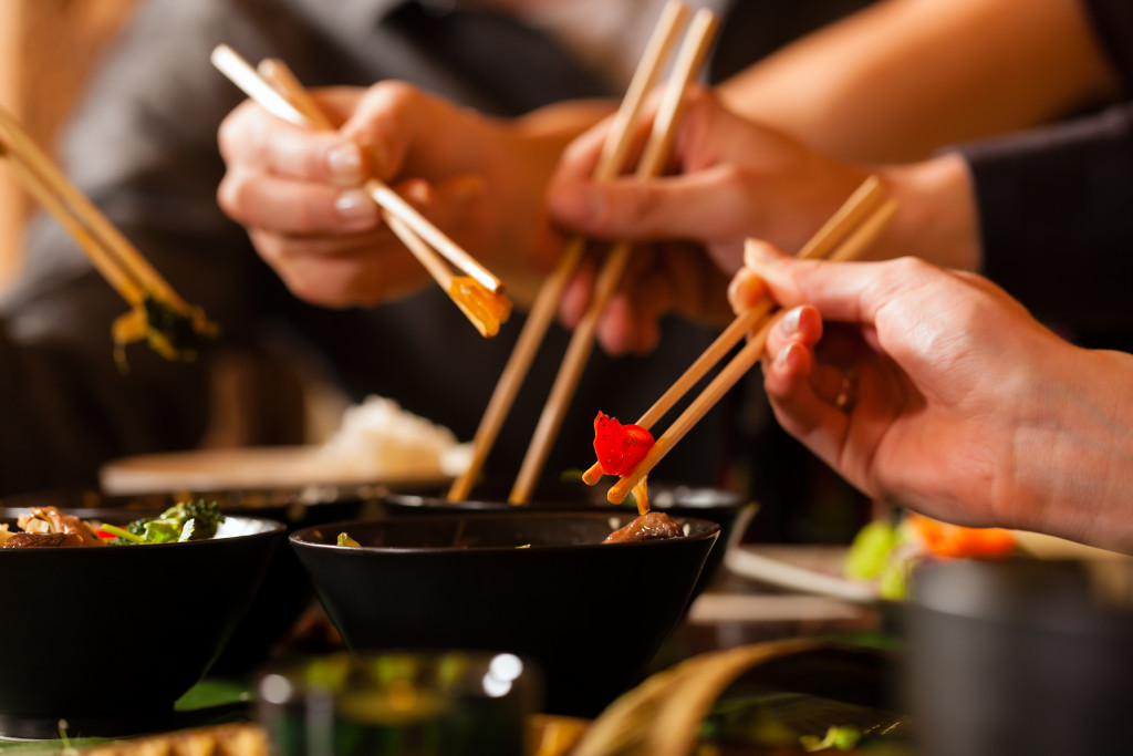 people holding chopsticks