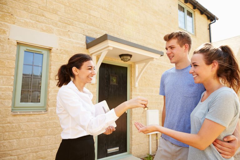 real estate agent handing house key