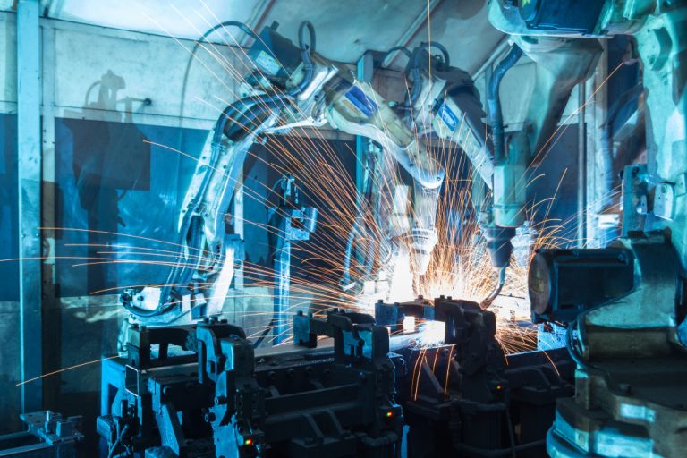 Welding robots used to assemble cars in an automobile factory.