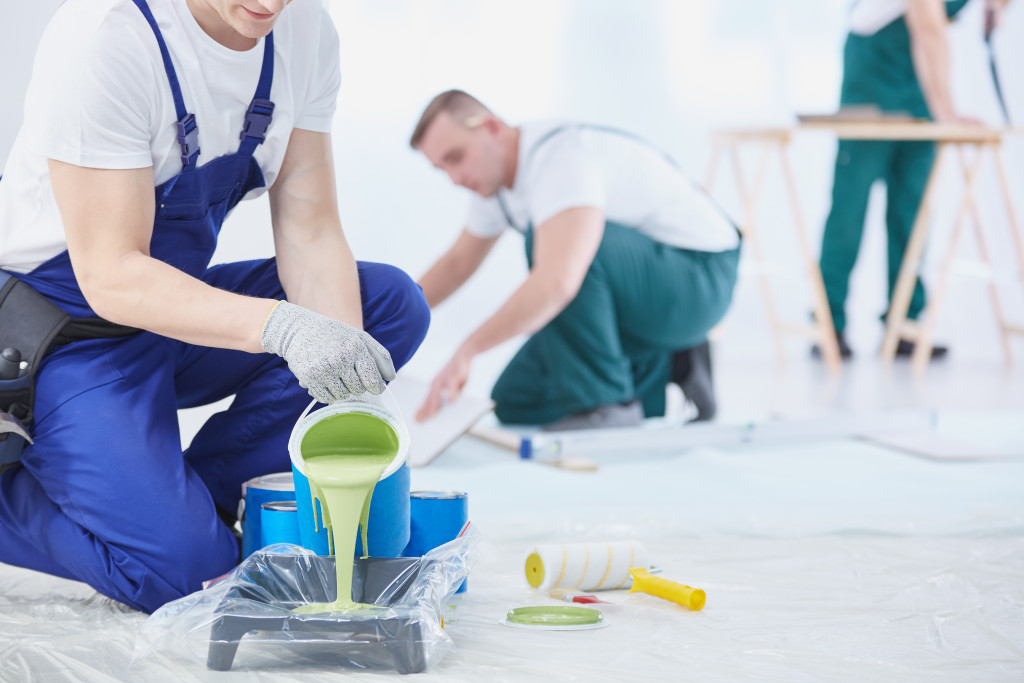 Workers mixing paint to use in a home renovation project.